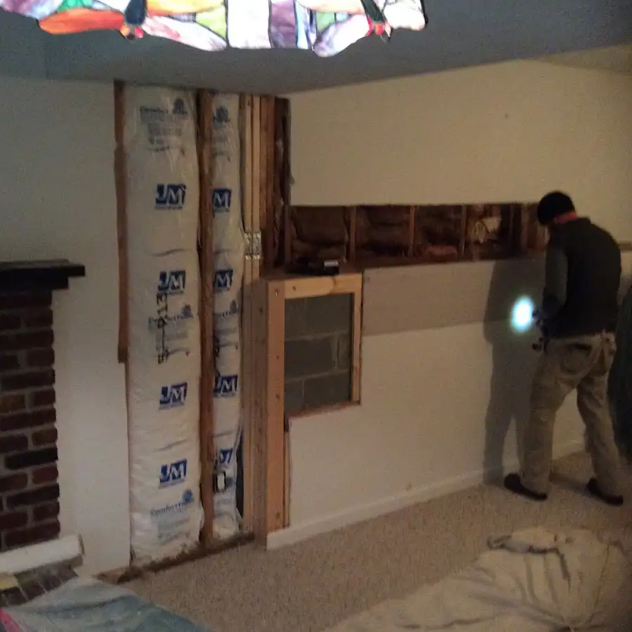 Restoration technician inspecting water damage in Fort Lee